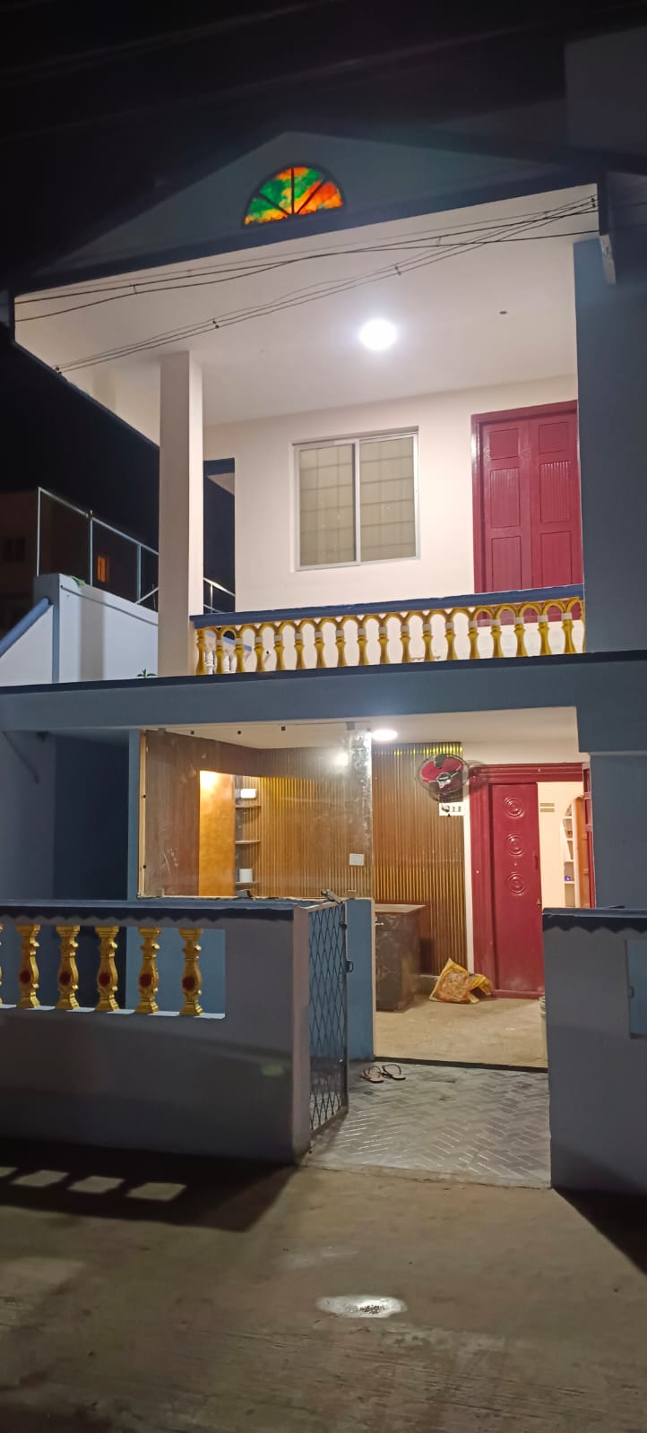 Poornabhishegam Homestay building at night